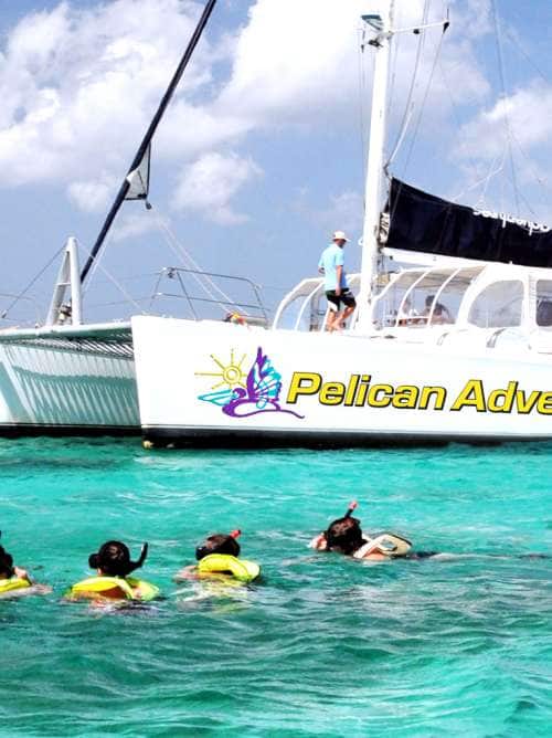 A picture of people snorkeling near a catamaran on an Aruba cruise excursion