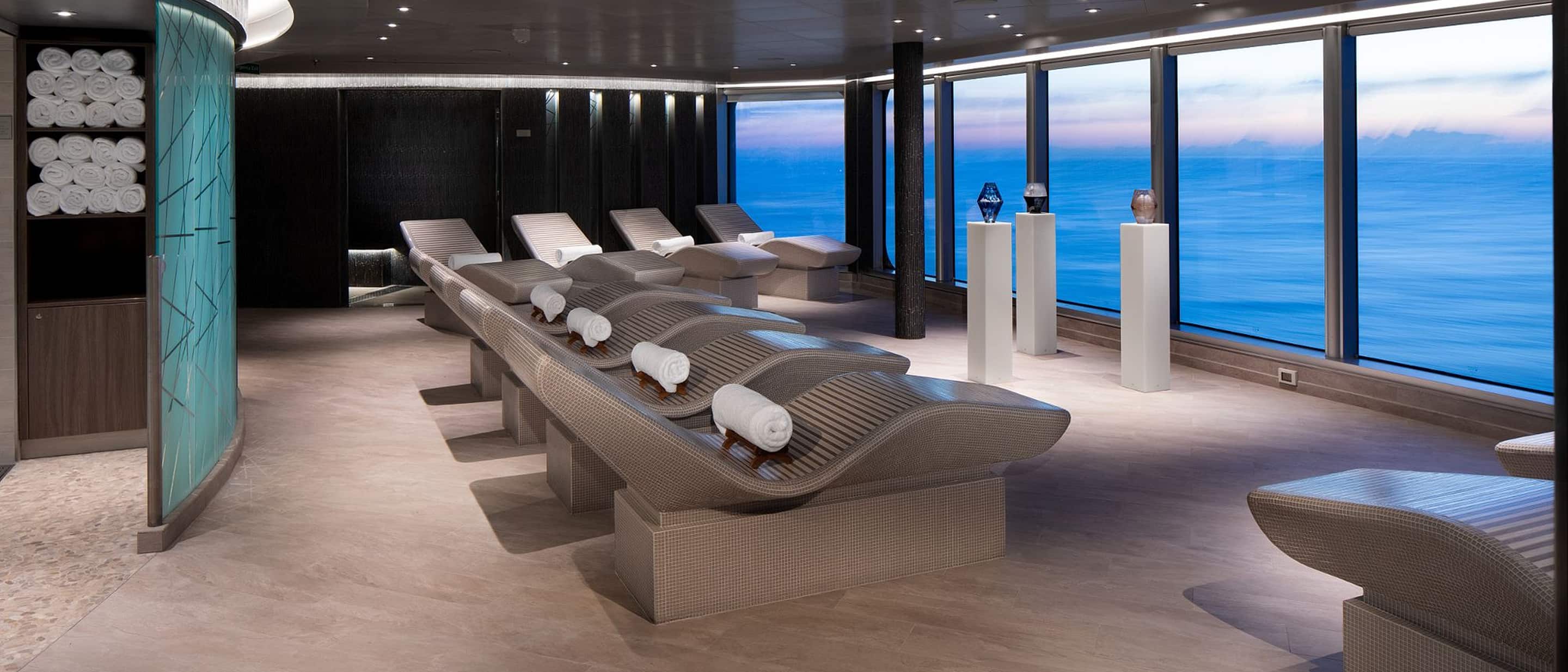 Ocean-view loungers and tranquil ambiance at Greenhouse Spa & Salon aboard a Holland America cruise ship.