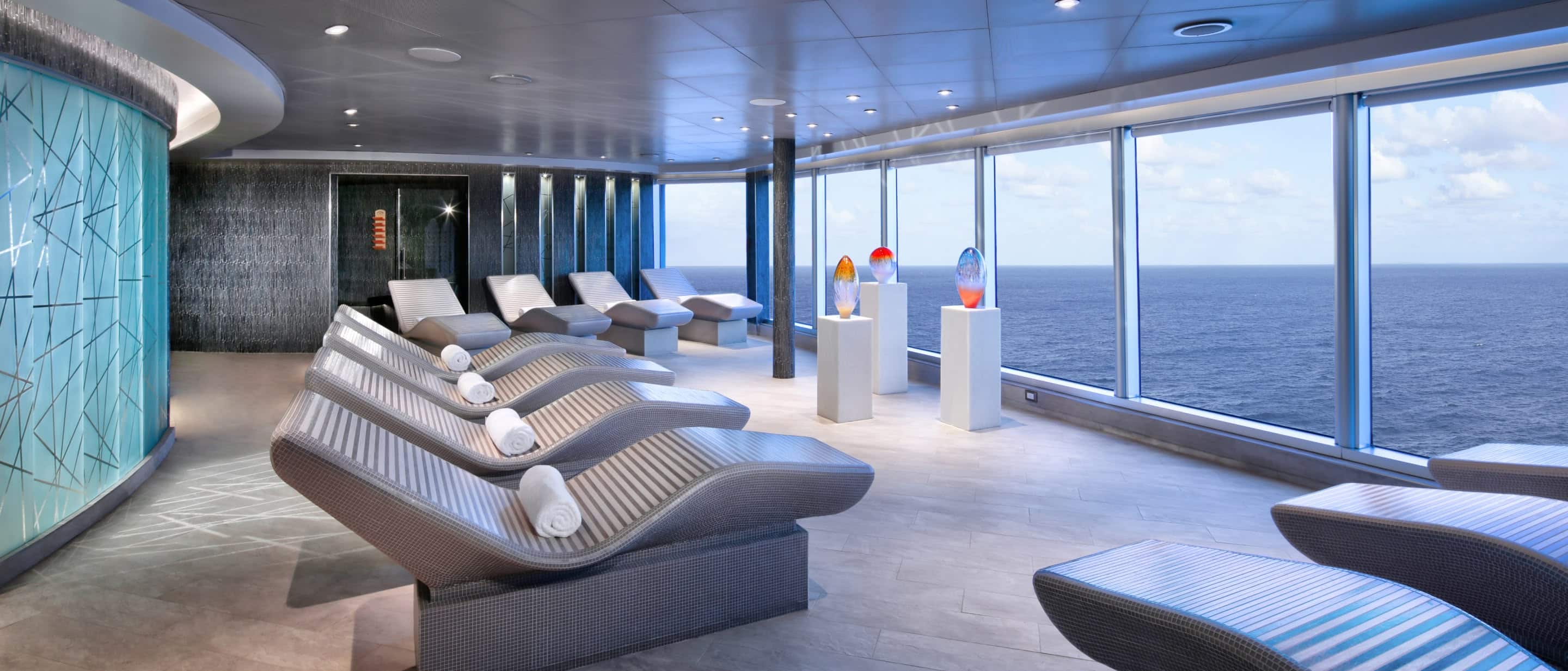Ocean-view loungers and tranquil ambiance at Greenhouse Spa & Salon aboard a Holland America cruise ship.