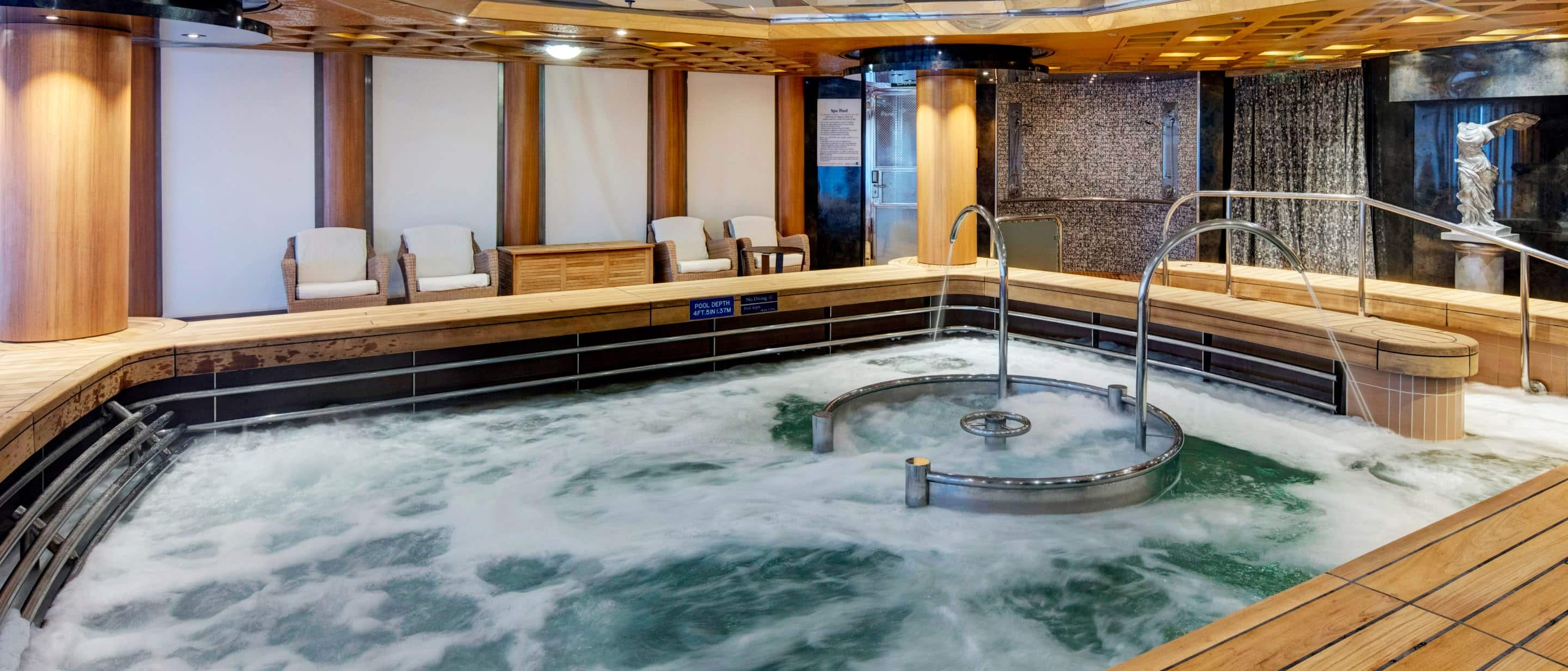 Hydropool area on the Holland America Line Noordam ship with bubbling water, handrails, and surrounding wooden seating.