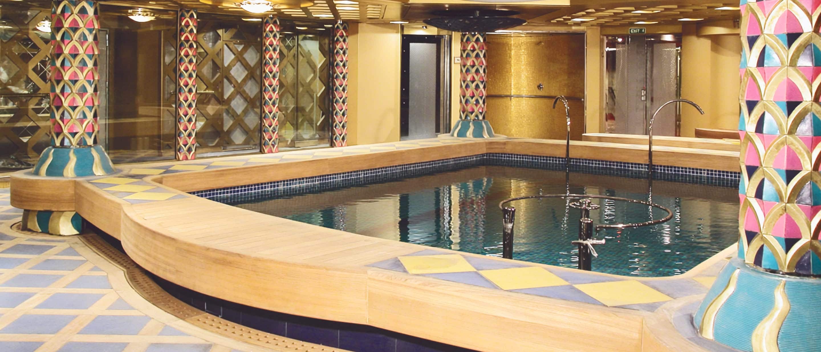 Hydropool in the spa featuring warm lighting and tranquil water elements on a Holland America cruise ship.