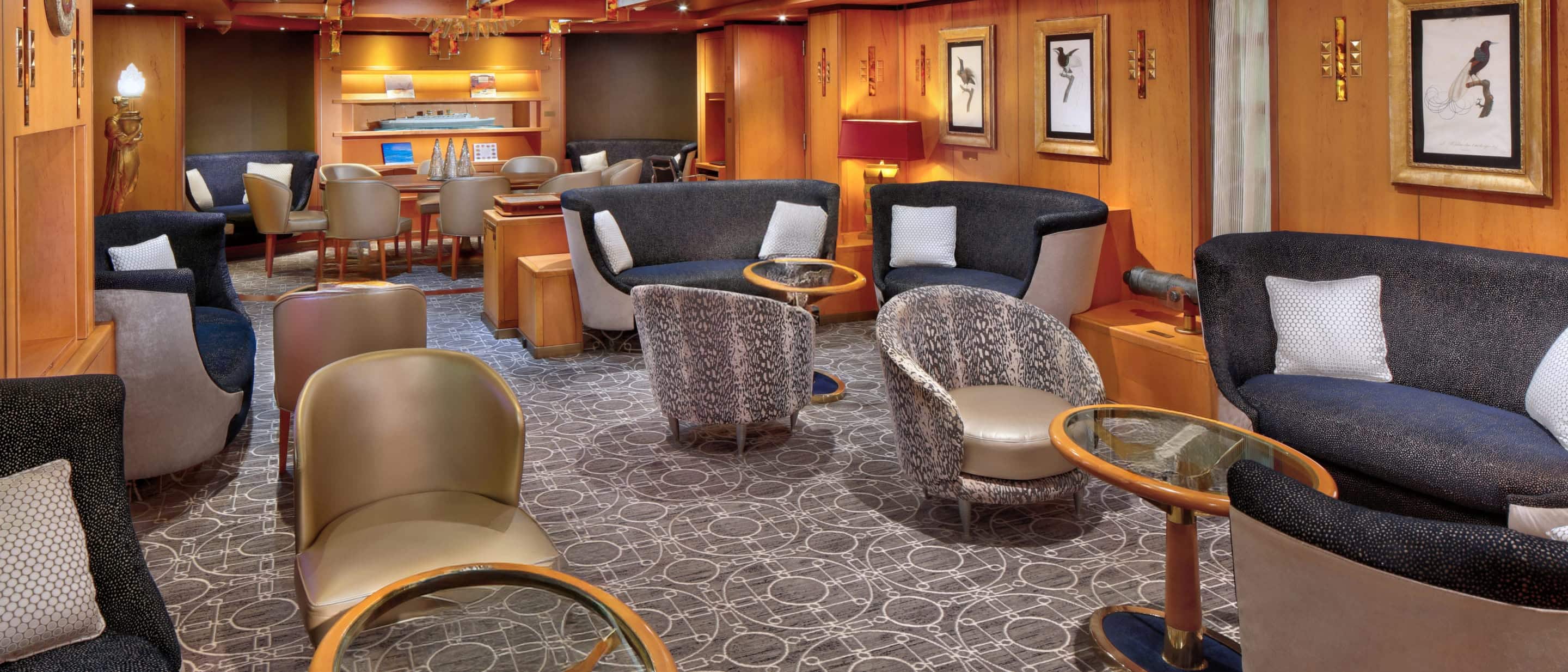 Lounge area on a Holland America cruise ship with upholstered chairs, small tables, artwork, and warm wood paneling.