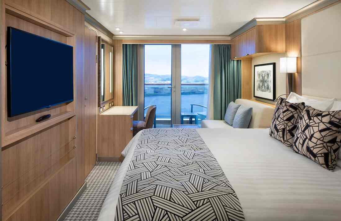 Verandah stateroom with sliding doors to a private balcony and ocean view on a Holland America cruise ship.