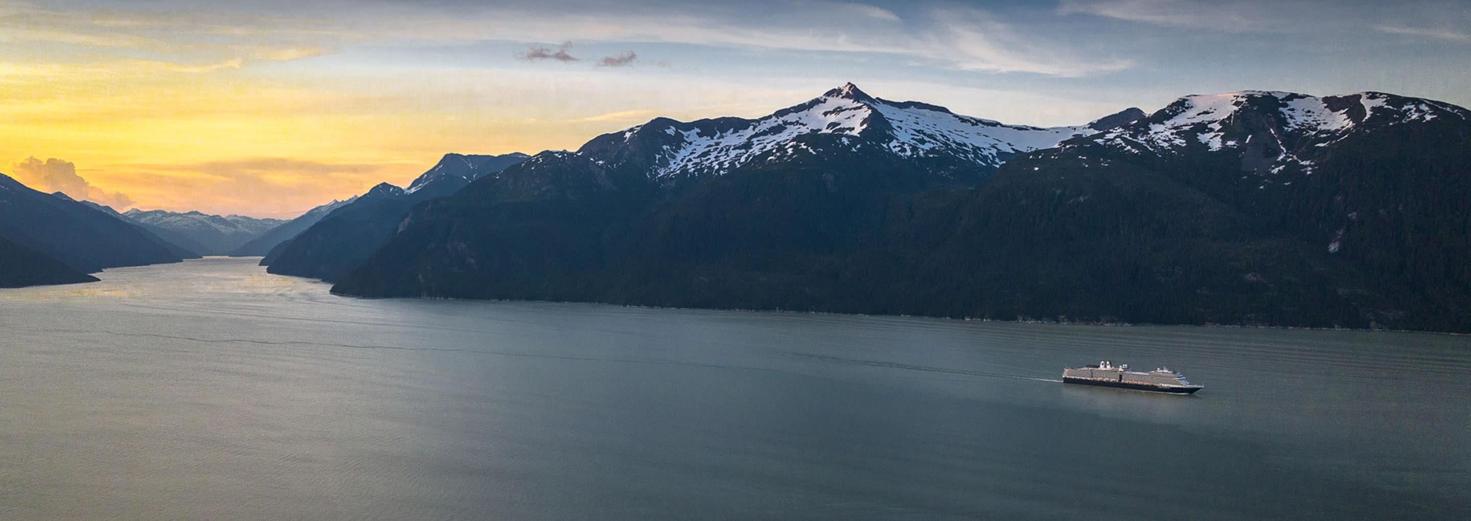 A Holland America cruise ship sails along Alaska's Inside Passage at dawn opens a dialog