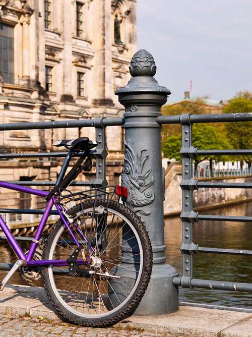 bicycle resting against a bridge in berlin, germany