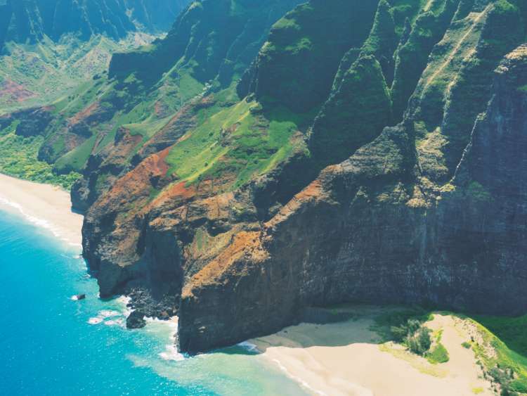 Aerial view of Hawaii's sandy beach and mountains