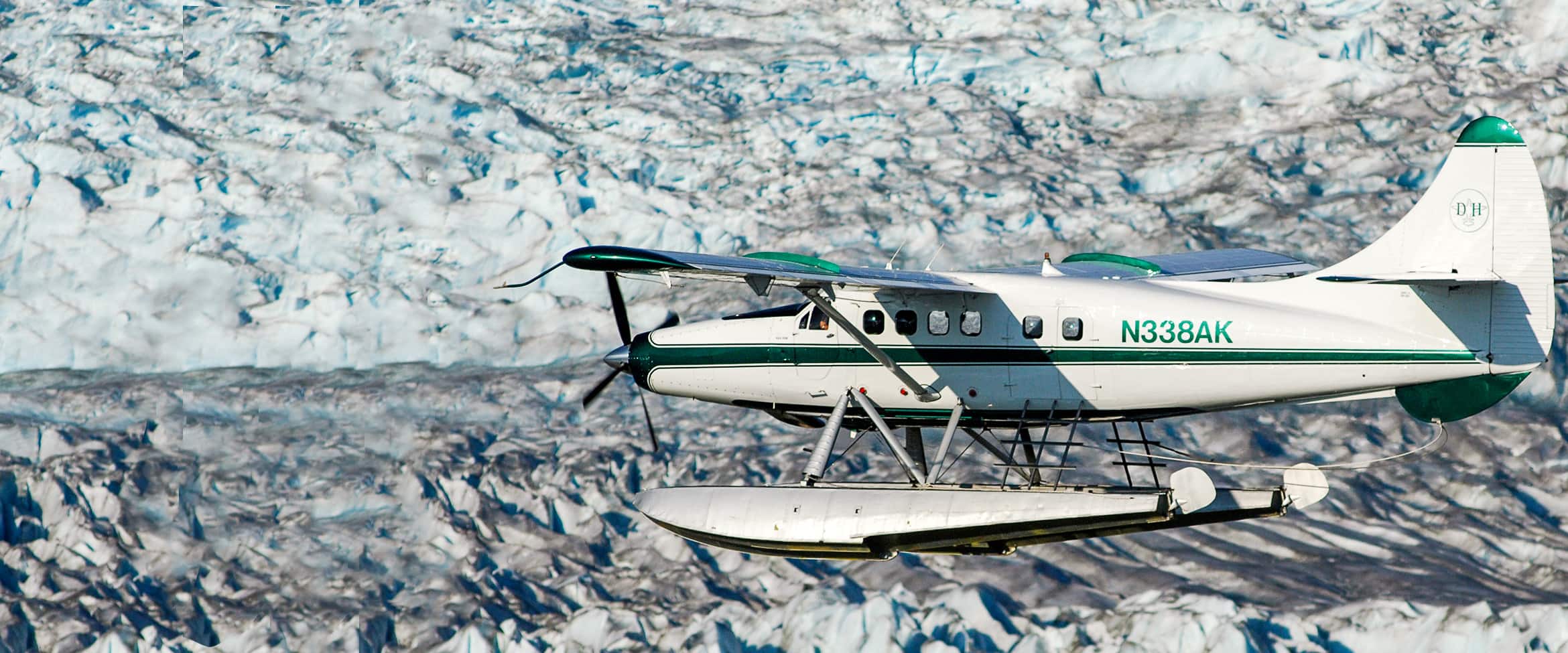 View of a seaplane flying over a glacier in Alaska