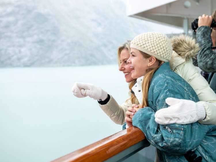 Mother and Daughter looking at an Alaska glacier from the deck of a Holland America ship