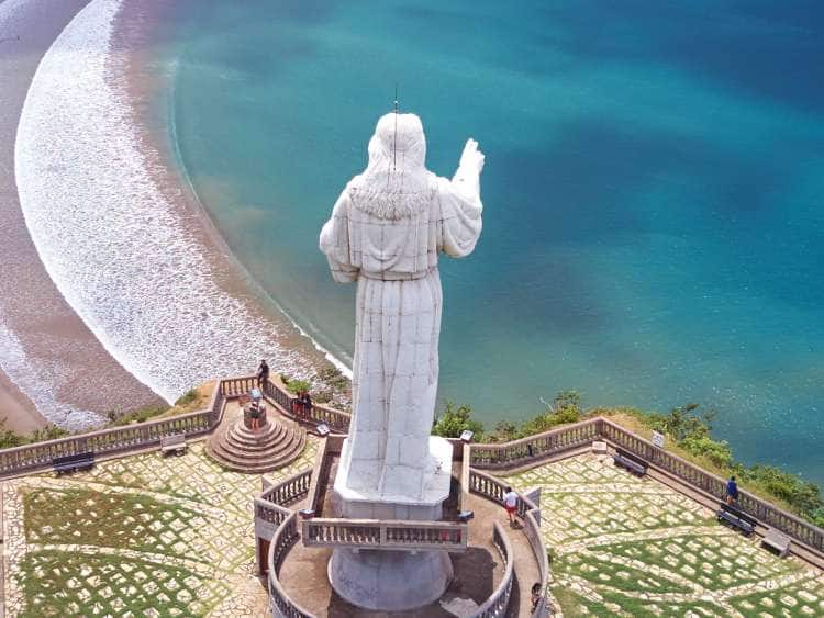 Aerial view of a religious statue overlooking a beach in San Juan Del Sur, Nicaragua on a Panama Canal cruise excursion