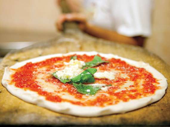 A cheese pizza with basil on top served on a Europe cruise