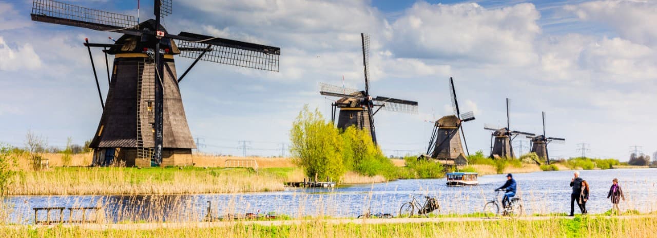 Traditional windmills seen in the Dutch countryside.