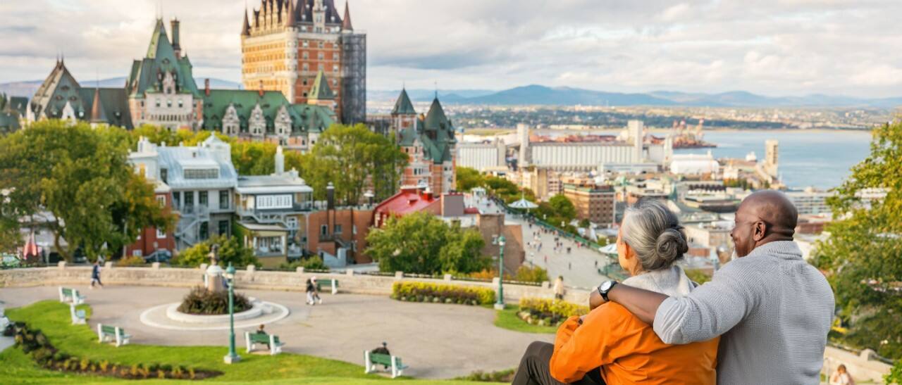 Couple enjoying a scenic view of Old Québec and the St. Lawrence River in September.
