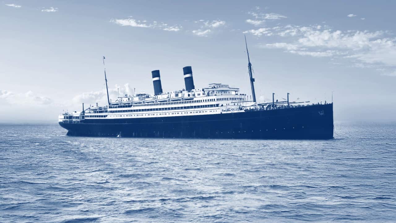 Vintage ocean liner sailing across open water.
