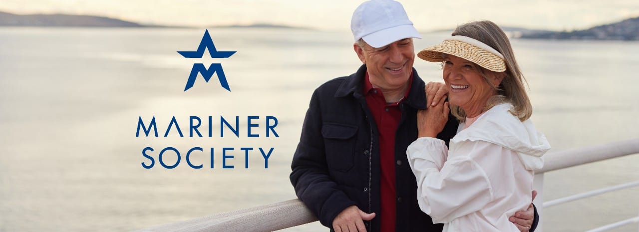 A smiling couple standing on a waterfront deck with the Mariner Society logo, symbolizing travel and exclusive cruise experiences.
