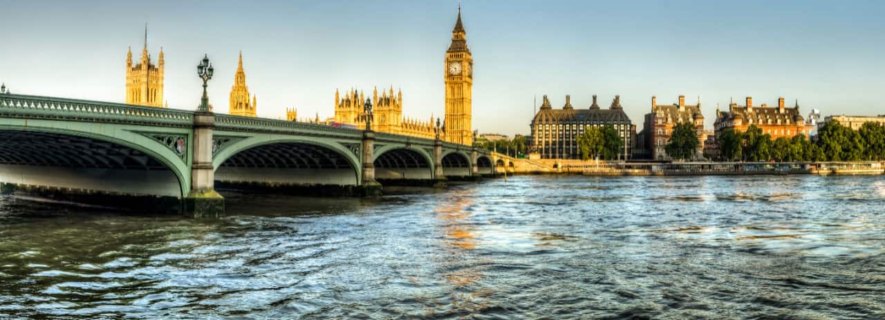 A view of the bridge over the Thames with the London Tower in the background.