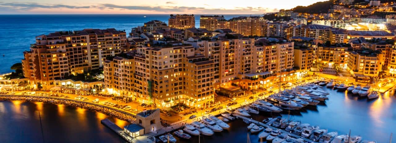 An aerial view of the city of Monaco at night.