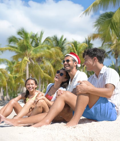 Family sitting on the beach during the Holidays