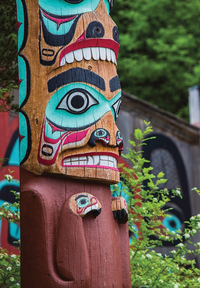 a vibrant Tlingit totem pole in Saxman Native Village in Ketchikan, Alaska