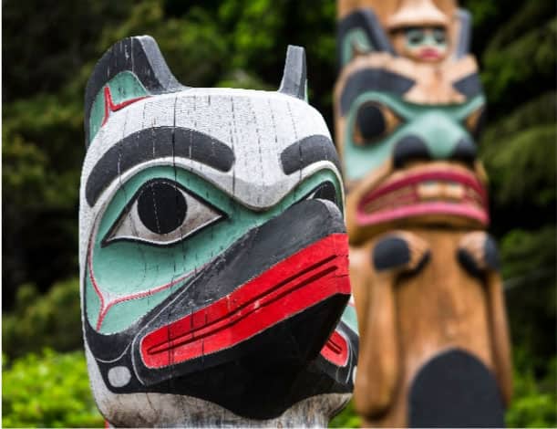 Two sacred totem poles carved and painted by Tlingit artisans in Saxman Village, Ketchikan, Alaska