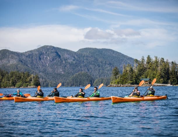 a group of people enjoying a kayak tour in the Siginaka Islands, located near Sitka, Alaska.