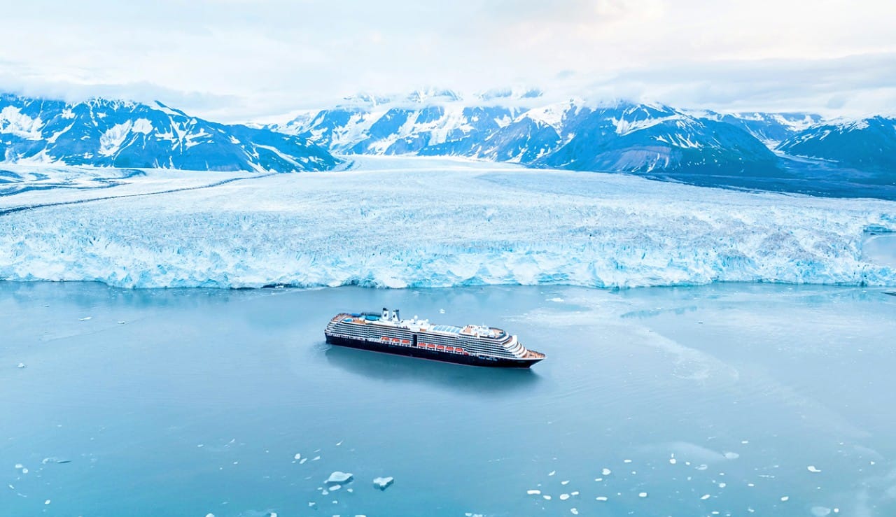 A Holland America cruise ship anchored near a Hubbard Glacier in Alaska