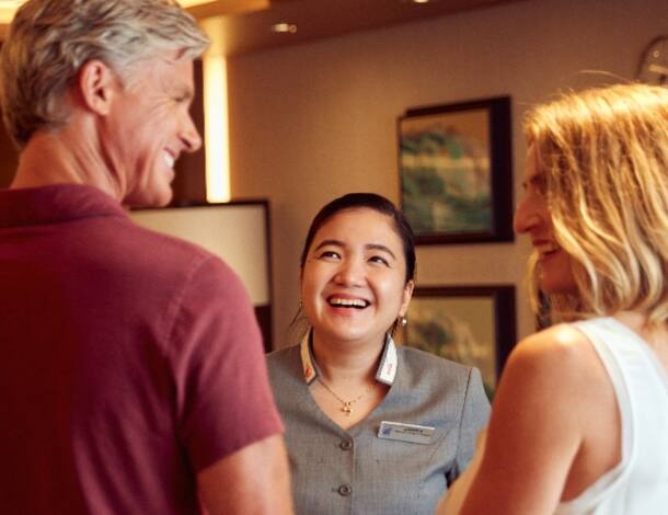 Hostess smiling to guests couple on Neptune Lounge