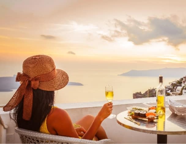 Tourist enjoying sunset at Santorini, Greece