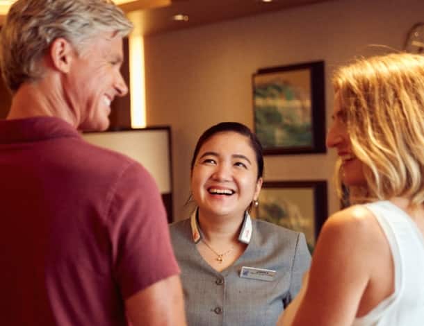 Hostess smiling to guests couple on Neptune Lounge
