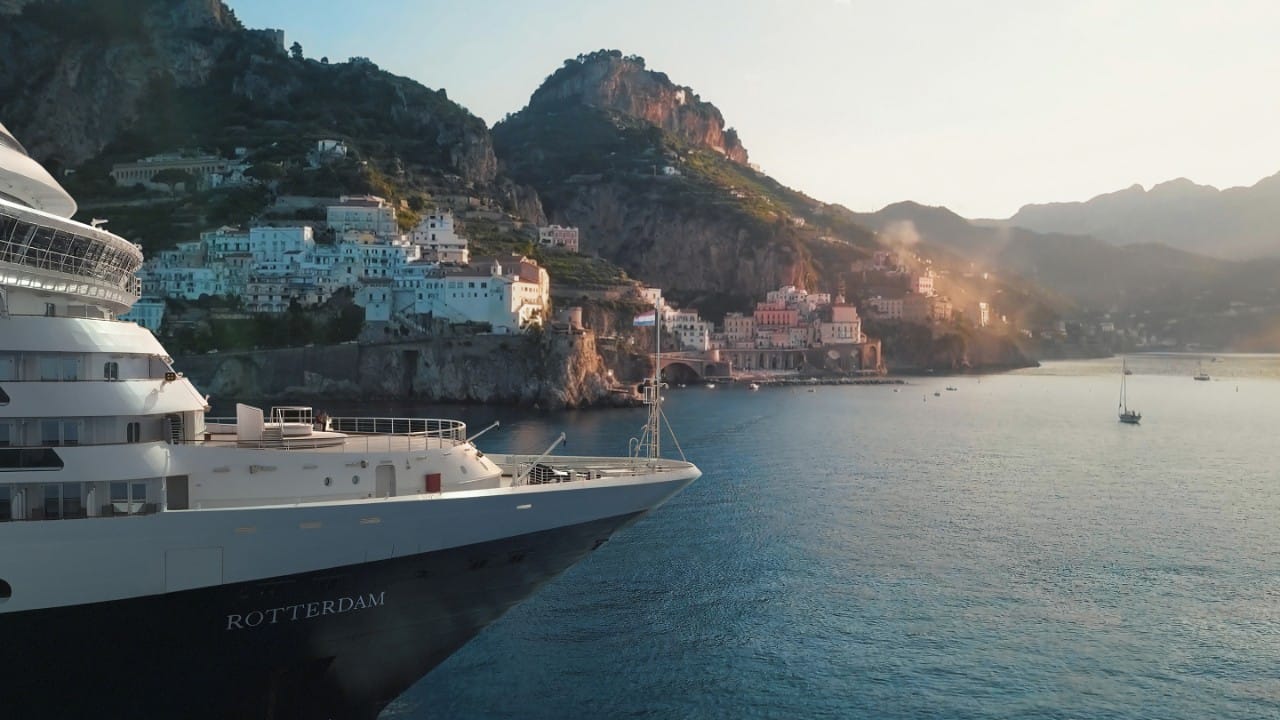 Holland America Line cruise ship deck view with ocean backdrop.