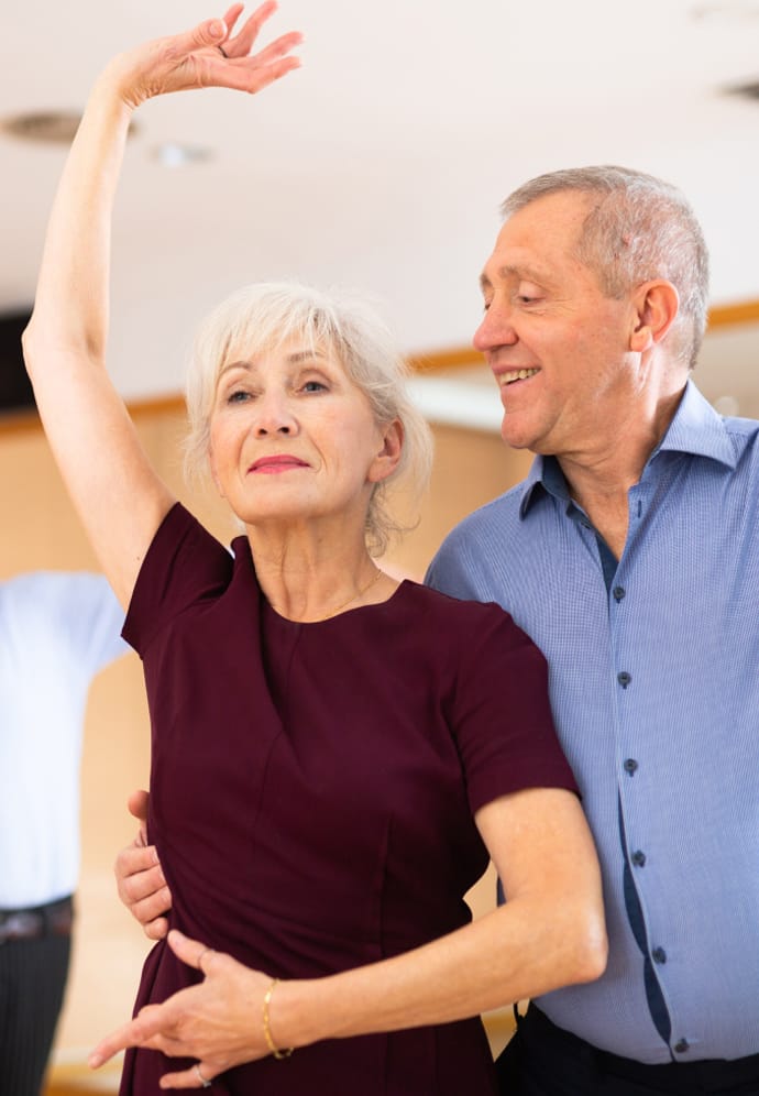 Couple taking a ballroom dance class.