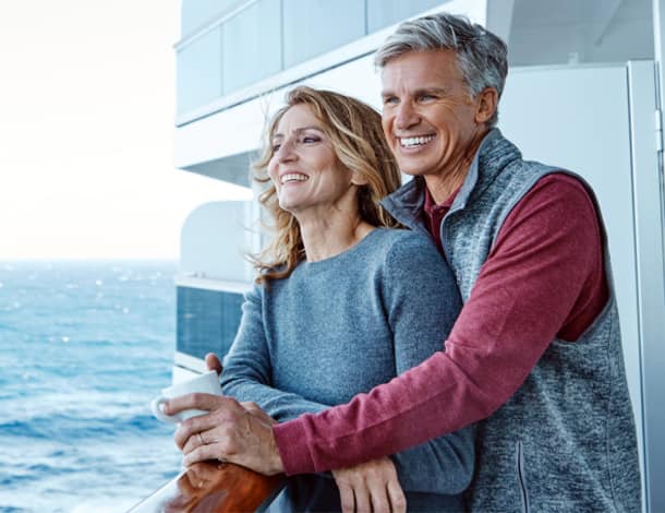Couple embracing on ship deck.