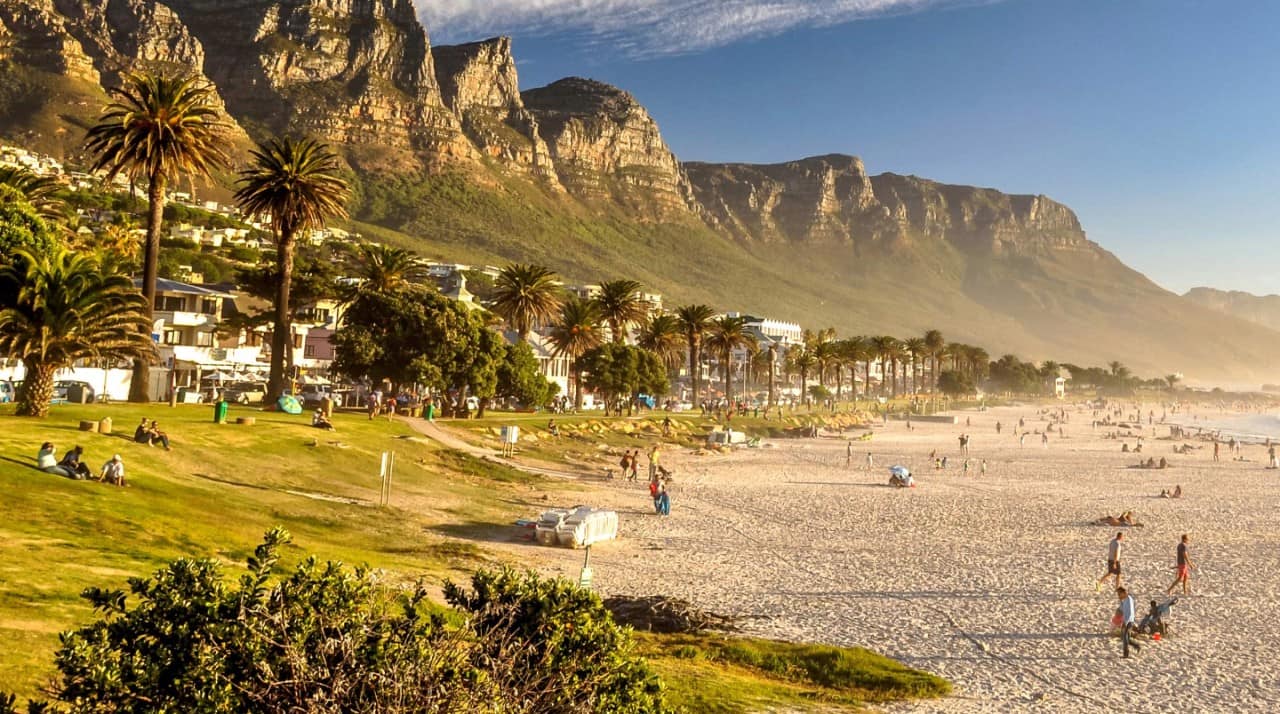 Camps Bay Beach with Table Mountain seen in the distance near Cape Town, South Africa.