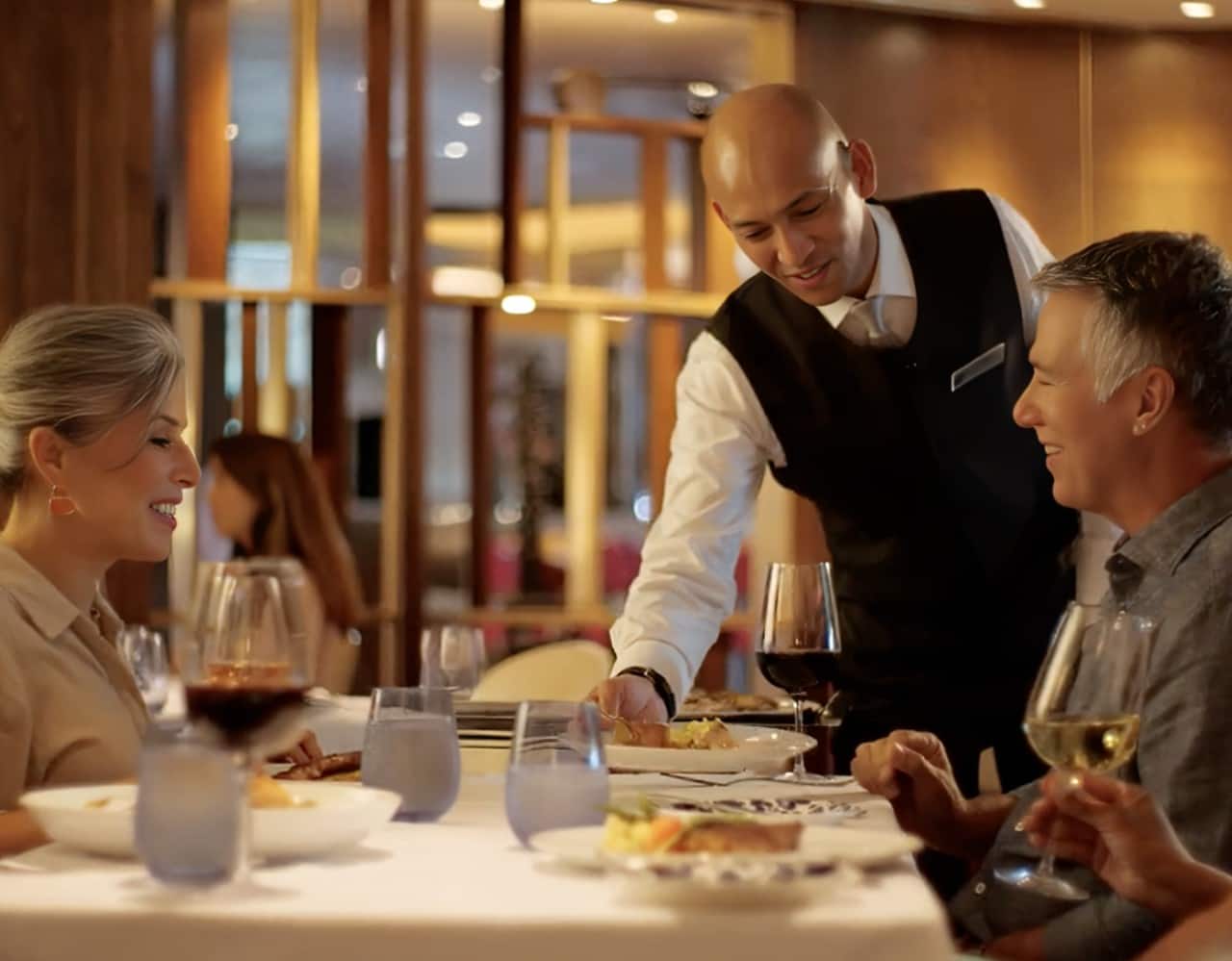 Waiter setting down a plate of food
