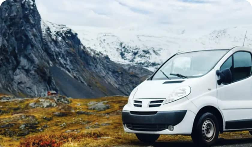 White van in snowy mountains.