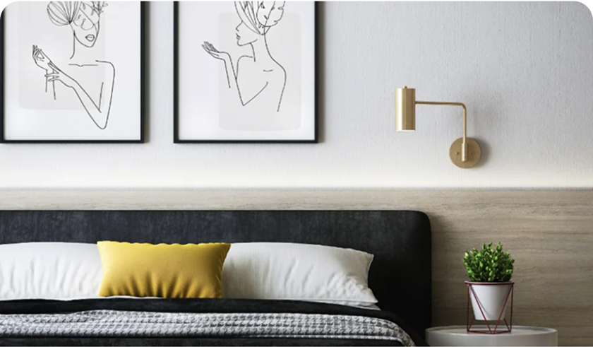 Tidy hotel room with large bed and art hanging on the wall.