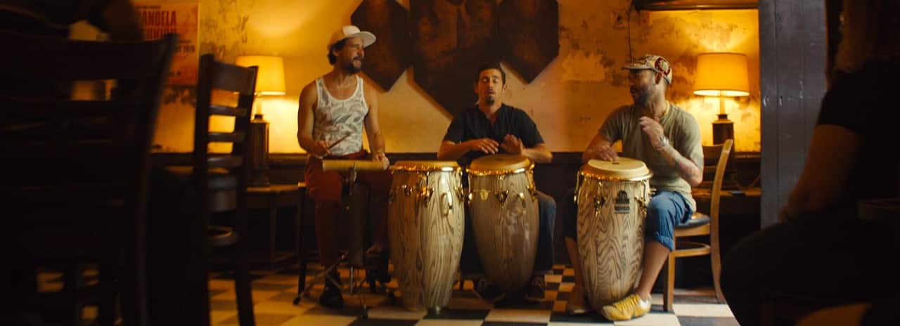 3 musicians drumming in a bar in Puerto Rico.