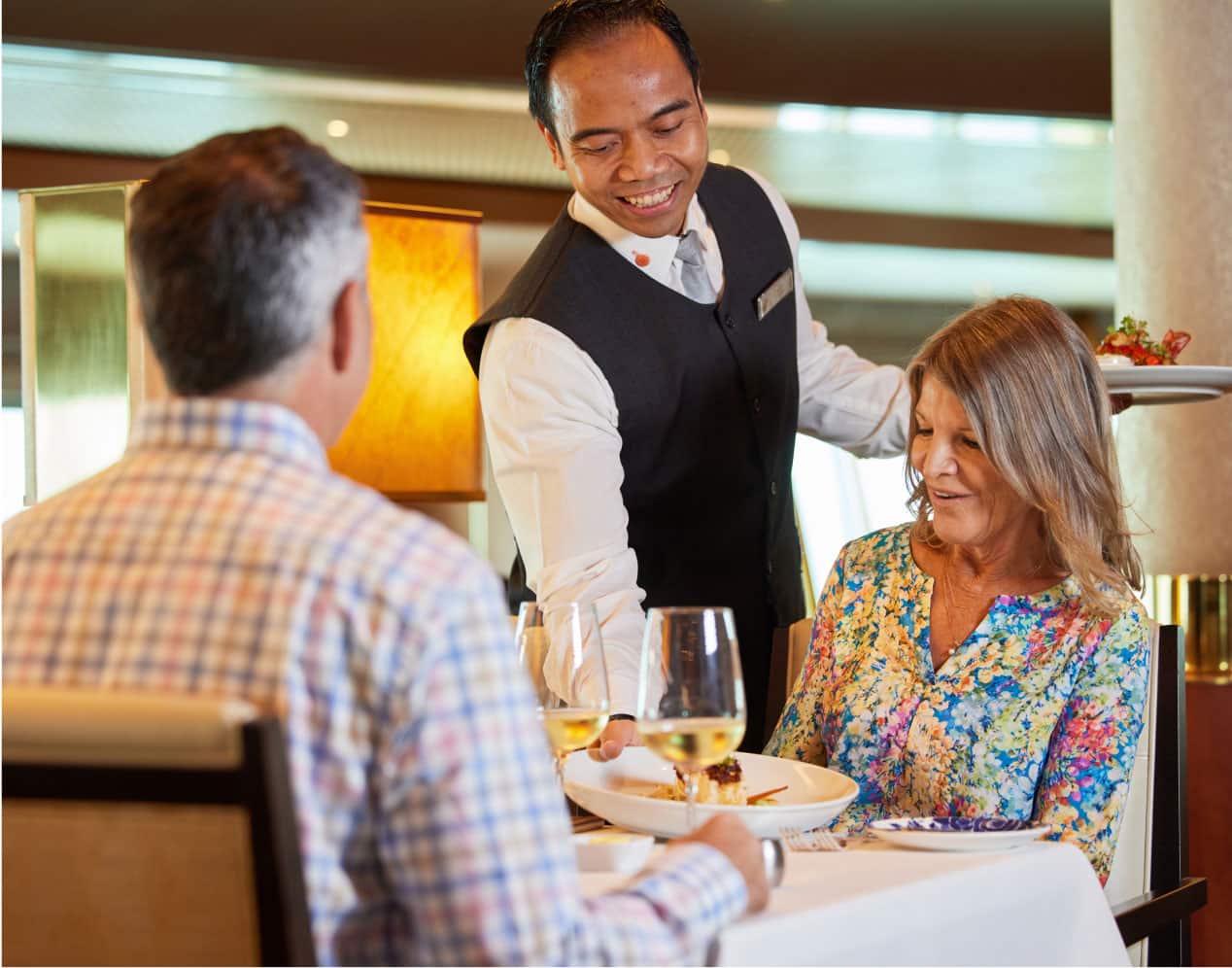 Waiter setting down a plate of food