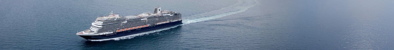 Cruise ship sailing near RelaxAway, Half Moon Cay™ with white sandy beaches and clear blue waters.