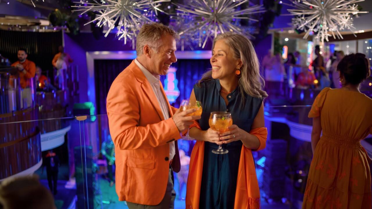 Woman wading in water in the Caribbean, a destination visited on an all-inclusive, luxury Seabourn cruise. 