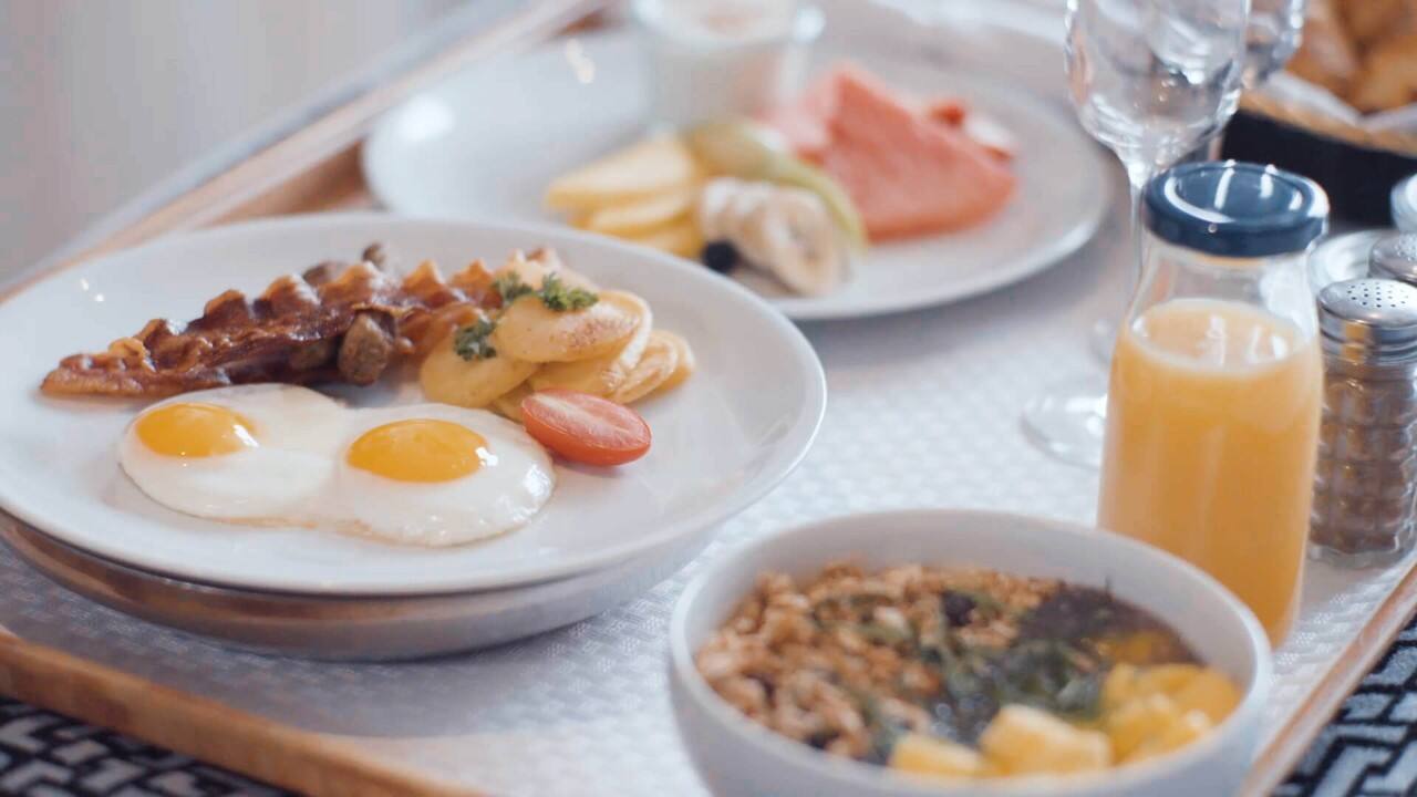 Breakfast spread with eggs, pastries, and juice served on a Holland America cruise.