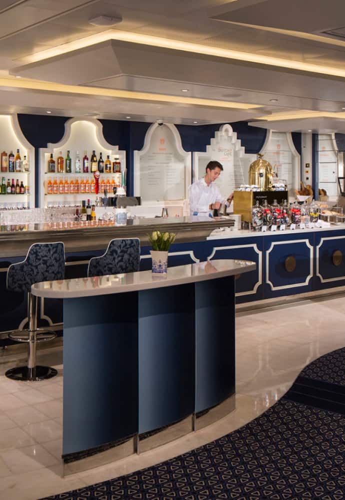 A person behind the bar in the Grand Dutch Cafe.