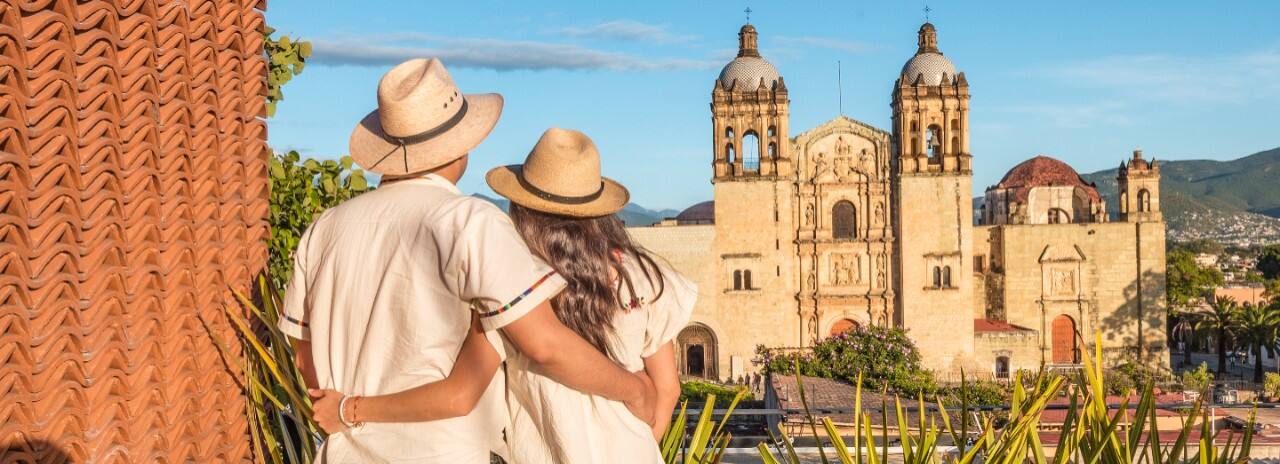 A couple enjoying the view of a church in Oxaca, Mexico..