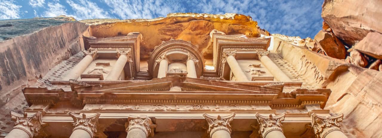 A view looking up at the Treasury Tomb in Jordan.