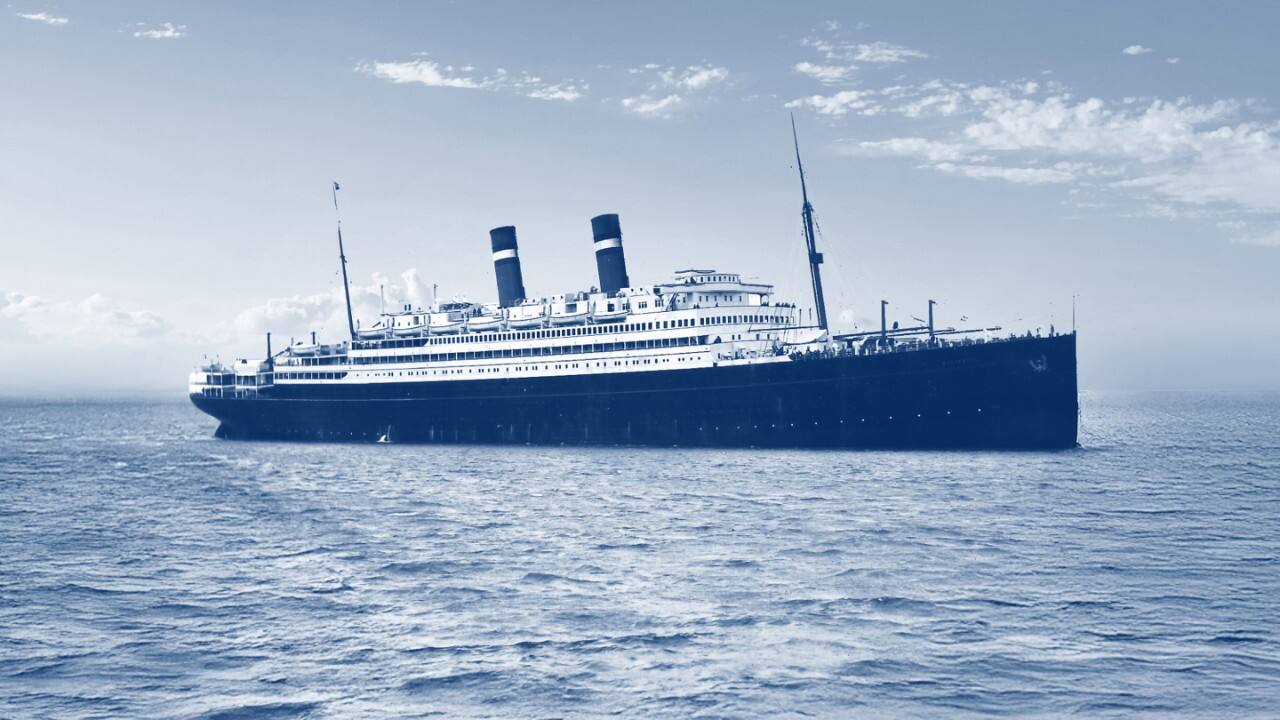 Vintage ocean liner sailing across open water.