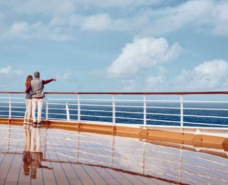 Couple admiring view from ship deck